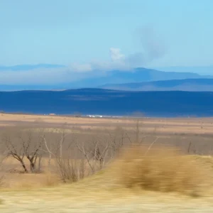 Scenic landscape with distant smoke and dry brush.